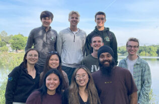 group of students smiling in an outdoor area.